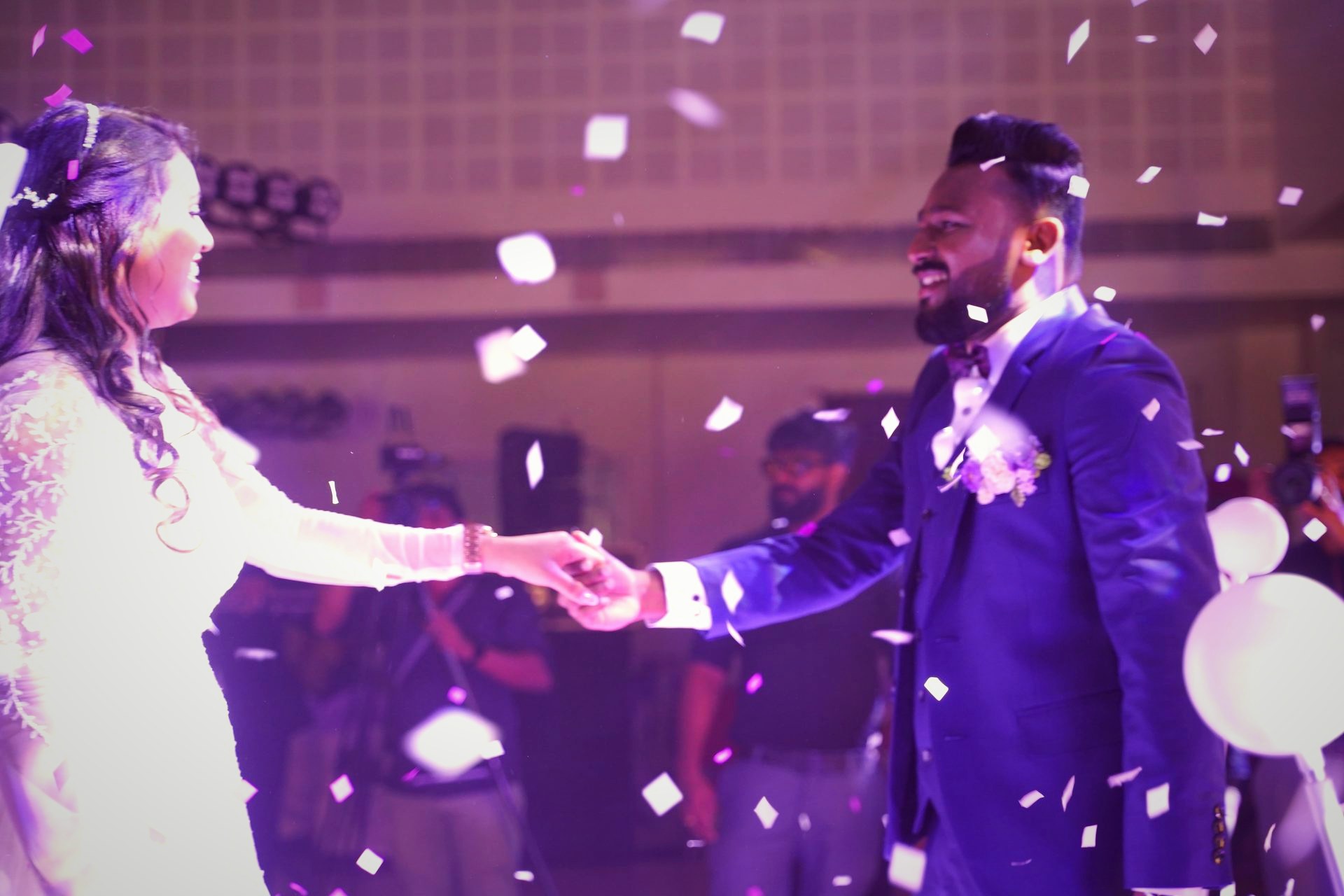 Reaching for each other through a burst of confetti